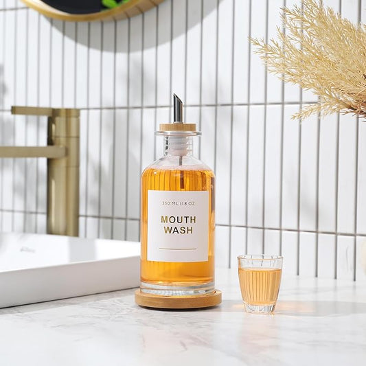 11.8OZ Glass Mouthwash Dispenser for Bathroom with Stainless Steel & Bamboo Nozzle, Mouthwash Cup Reusable, Bamboo Tray, and Elegant Gold Sticker.(Clear