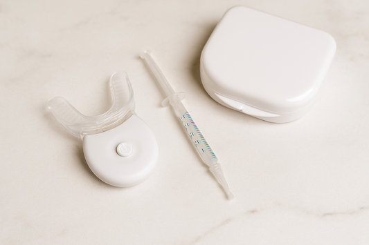 Dentora LED teeth whitening kit with mouthpiece, whitening gel syringe, and storage case arranged on a clean counter, symbolizing modern at-home whitening