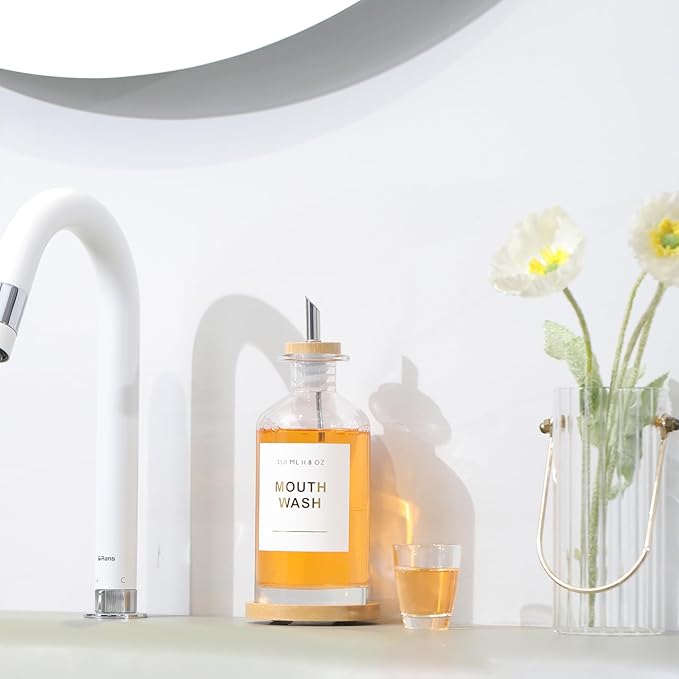 11.8OZ Glass Mouthwash Dispenser for Bathroom with Stainless Steel & Bamboo Nozzle, Mouthwash Cup Reusable, Bamboo Tray, and Elegant Gold Sticker.（Clear